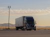 Tesla Sets April 2026 Volume Production for Semi Truck Tesla Semi truck parked at a charging station with Giga Nevada facility in the background
