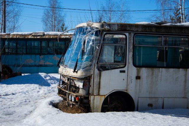 Rescue workers tend to an overturned tour bus on a Dominican roadside as police secure the crash scene.
